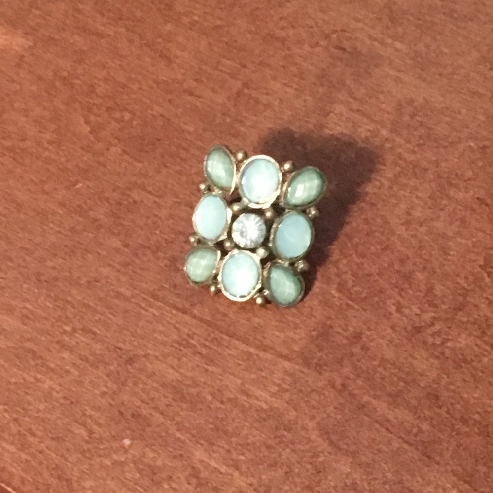 Mint green gems ring with gold colored trim.